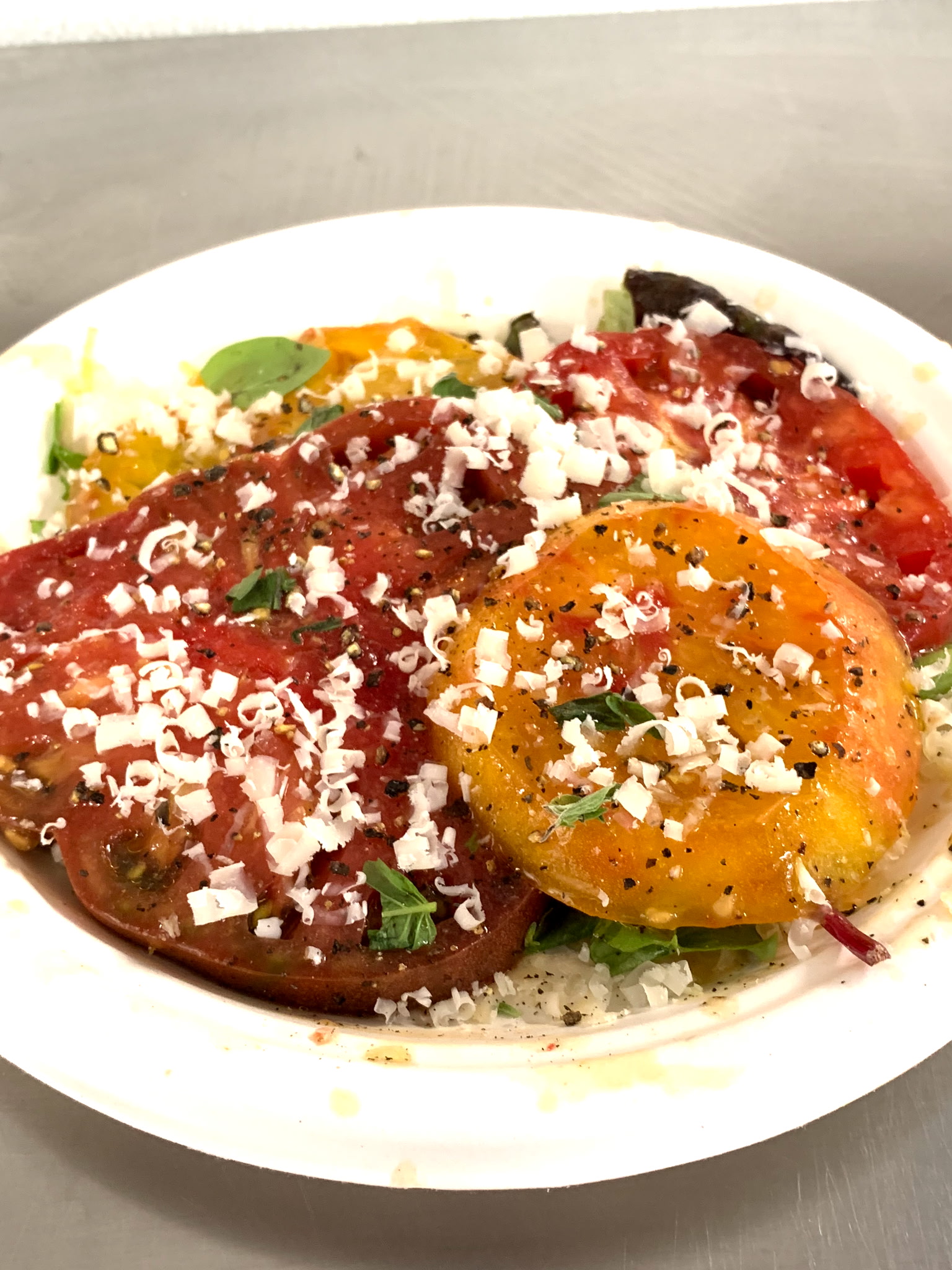 Heirloom tomato salad with shaved cheese and fresh herbs